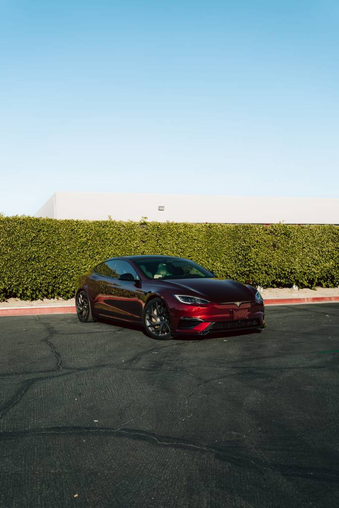 Red Tesla Model S with ceramic window tint at Iconic